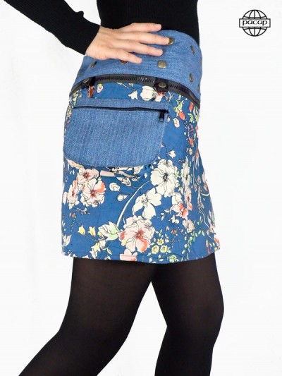 short skirt in thick blue jeans with detachable wide belt zipped and buttoned, bottom of the skirt printed Japanese flowers