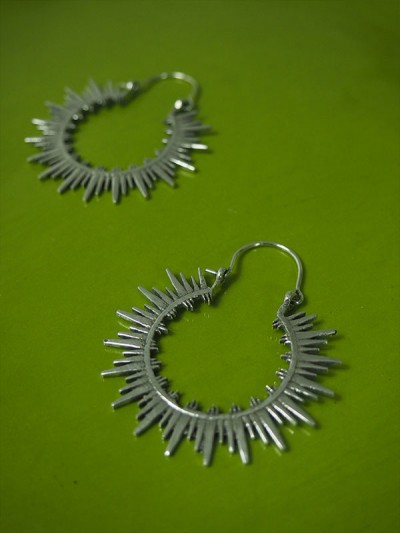 Silver-plated earrings on green background, medium size