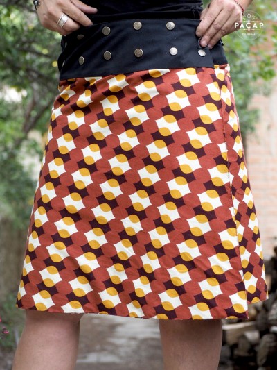 Women's wrap skirt in colorful cotton with adjustable waistband and button closure.