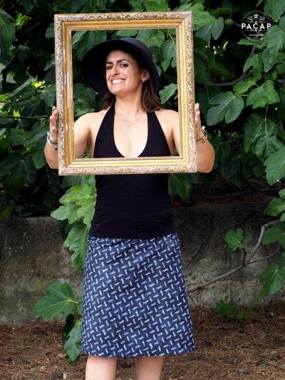 faded blue skirt with geometric pattern and woman holding a bottomless photo frame