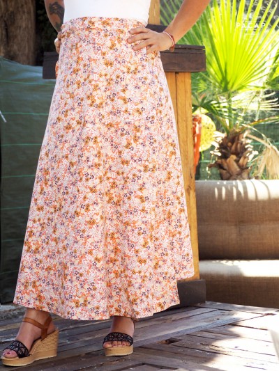 long salmon-colored wrap skirt with flowers tie belt