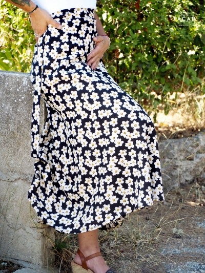 long, high-waisted black skirt with white floral print