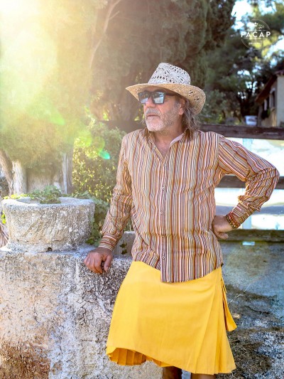 men's brown striped shirt with yellow kilt, straw hat and sunglasses